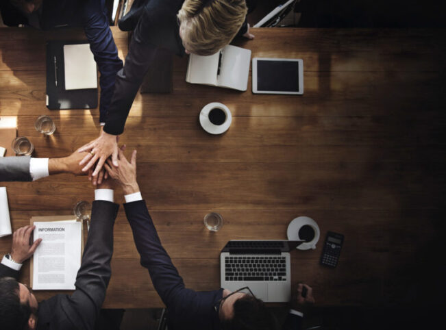 trenmead_multi_vendor_business-people-stacking-their-hands