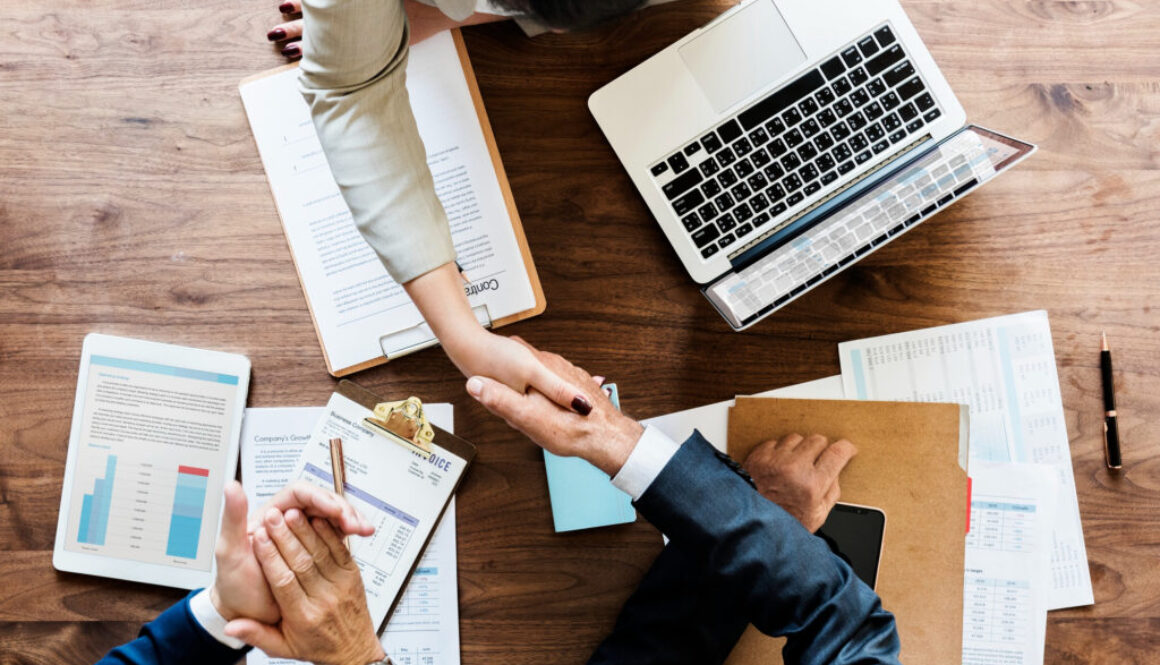 trenmead_business-people-shaking-hands-together